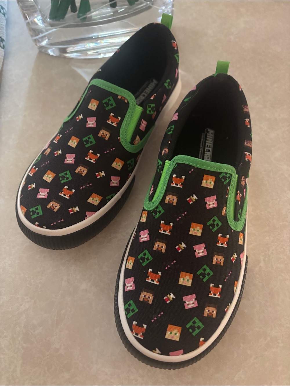 Kids Black Slip-On Sneakers with Green Trim and Pixel Character Print